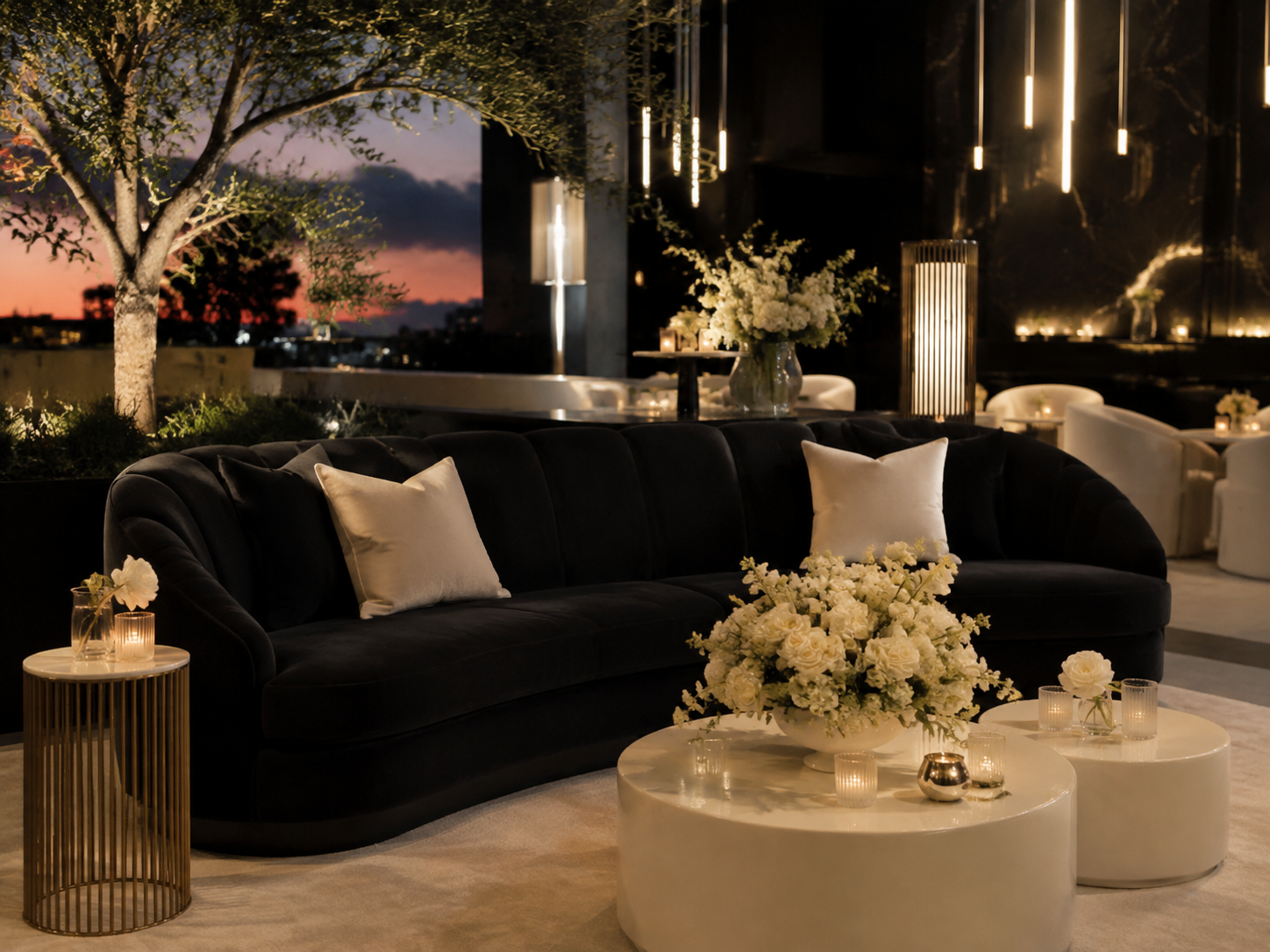 Elegant lounge seating with florals and candlelight styled for an evening celebration